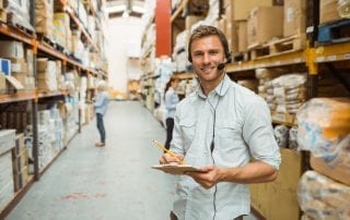 Employee in warehouse using two way radio headset